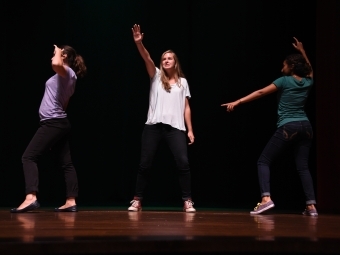 Health advisers dancing on stage as part of a skit