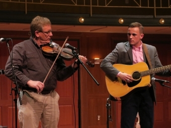 Scott Stegall Playing the Guitar on-stage with another person playing the fiddle