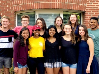 Health Advisers pose in front of brick wall