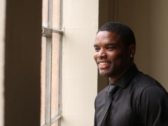 Kuntrell Jackson smiles while looking out a window