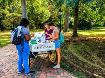 Student complete crafts at the Art Cart, stationed on campus