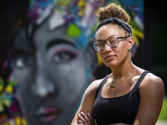Makayla Binter Artist Portrait in front of Mural