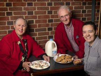 Harriet Kessler, Dennis Appleyard, and Grace Cain ’20 with plates of cookies