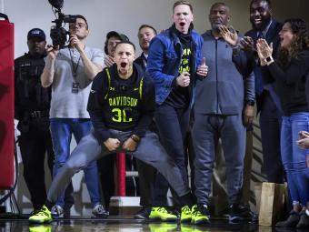 Steph Curry and Bryant Barr at a Basketball Game Cheering