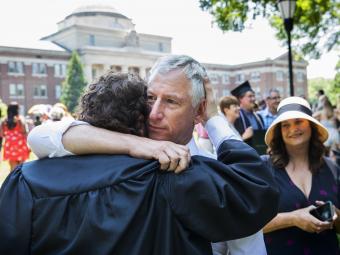 Family members hug after commencement