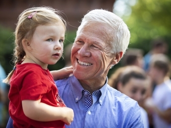 Bob McKillop holding his granddaughter