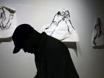 Silhouette of Jageth Weerasinghe as he works on his exhibit