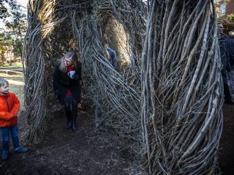 Patrick Dougherty Sculpture with kids visiting