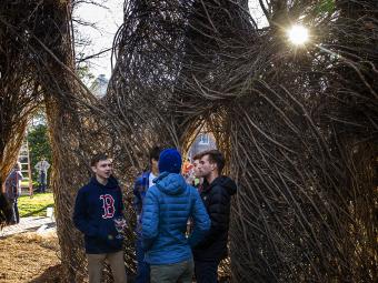 Patrick Dougherty Sculpture with students at sunset