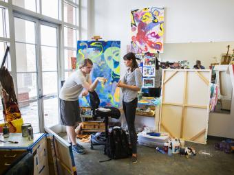 Student and Prof. Katie St. Claire talking in Painting Class