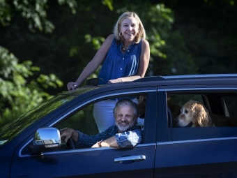 Family with Dog smiling through car