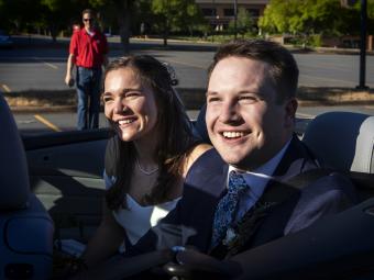 Caroline Bell '17 with husband Tyler Peterson smiling in car 