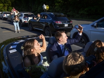 Caroline Bell '17 and Tyler Peterson waving from car 