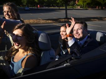 Caroline and Tyler waving with Hollins Worsley '18 driving 