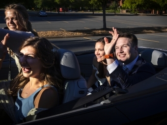 Caroline and Tyler waving with Hollins Worsley '18 driving