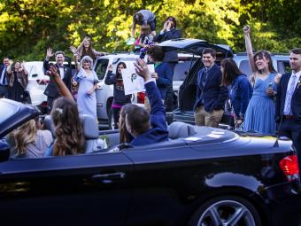 Guests waving from cars 