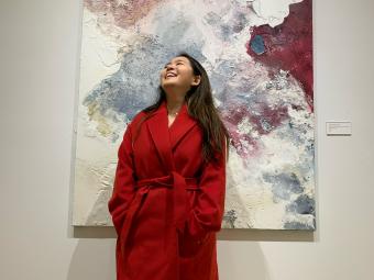 Student Coco Peng Posed in Front of Painting Looking Up 