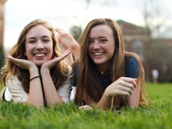 Carter Cook and Caroline Roy smiling on chambers lawn 