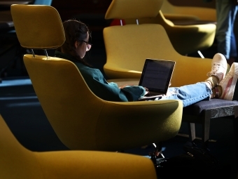 Student Studying in Library on Laptop