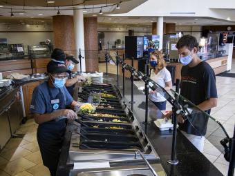 Masked Vail Commons Staff Serve Salads to Masked Students