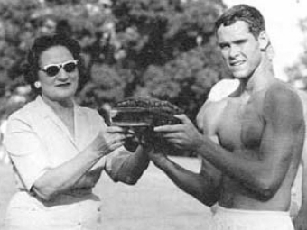 Mrs. Whittle hands cake to race winner