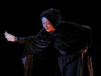 Ariel Chung in Macbeth wearing cape and mask