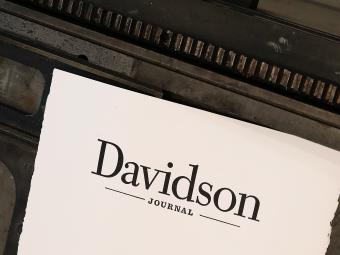 Paper with the "Davidson Journal" wordmark printed on it atop a letterpress
