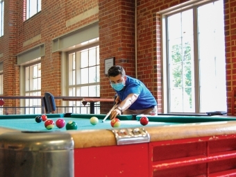 Student Plays Pool with Mask On