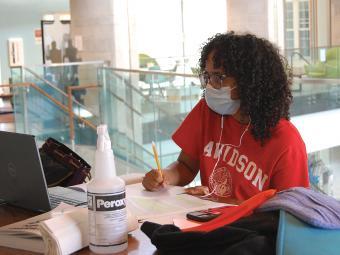 Student Studying with Mask, Cleaning Products, Laptop