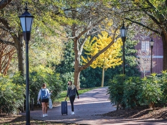 Students in Masks with Suitcase Move Out