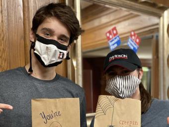 Students with masks at a dining services event