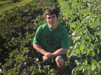Ethan Kearns '23 in green farm crop rows