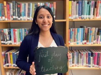 Maribel Hernandez '20 at her Internship with a chalk board that reads "First day of teaching"