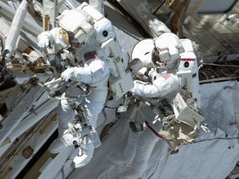 Chris Cassidy (right) and Tom Marshburn complete a space walk to inspect and replace a pump controller box leaking ammonia coolant on the International Space Station