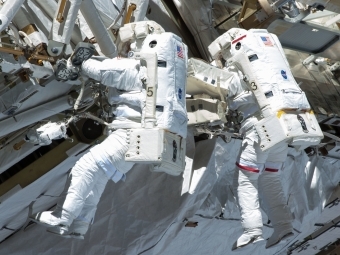 Chris Cassidy (right) and Tom Marshburn Fixing a pump controller box leaking ammonia coolant on the International Space Station