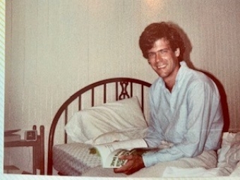 young Tony Snow sitting on bed