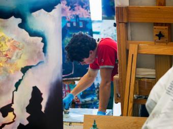 Isaac Scharbach ’21 painting in his art studio
