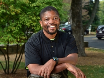 Professor Issac Bailey headshot smiling outdoors