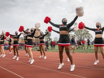 Davidson Cheerleaders Performing at Football Game in Masks