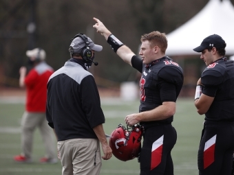 Football Players talk to Coach Abel