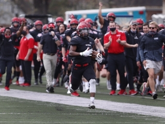 Davidson Football Player Gains Yards with Full Team Cheering Them on in Background