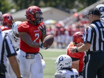 Jorrell Story as a Football Player Holds Ball and Talks to Referee