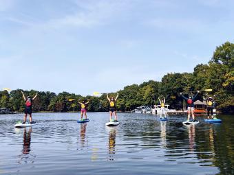 Students on paddle boards at Lake Campus