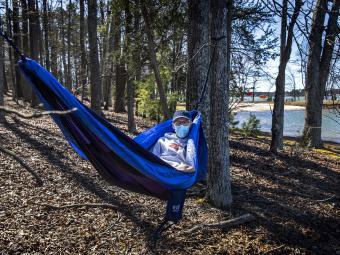 Student in Hammock at Lake Campus with Mask