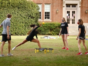 Students in Masks Play Spike Ball on Chambers Lawn