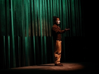 Student Performing in Theatre Piece with Mask