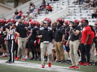 Football Team on Sidelines and Coach Abel Cheering