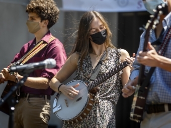 Student Playing Banjo and Other Musicians