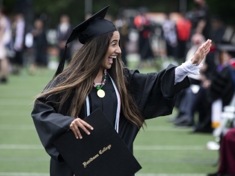 Student Holding Diploma at Commencement