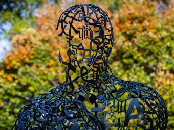 Plensa campus art sculpture with autumn background